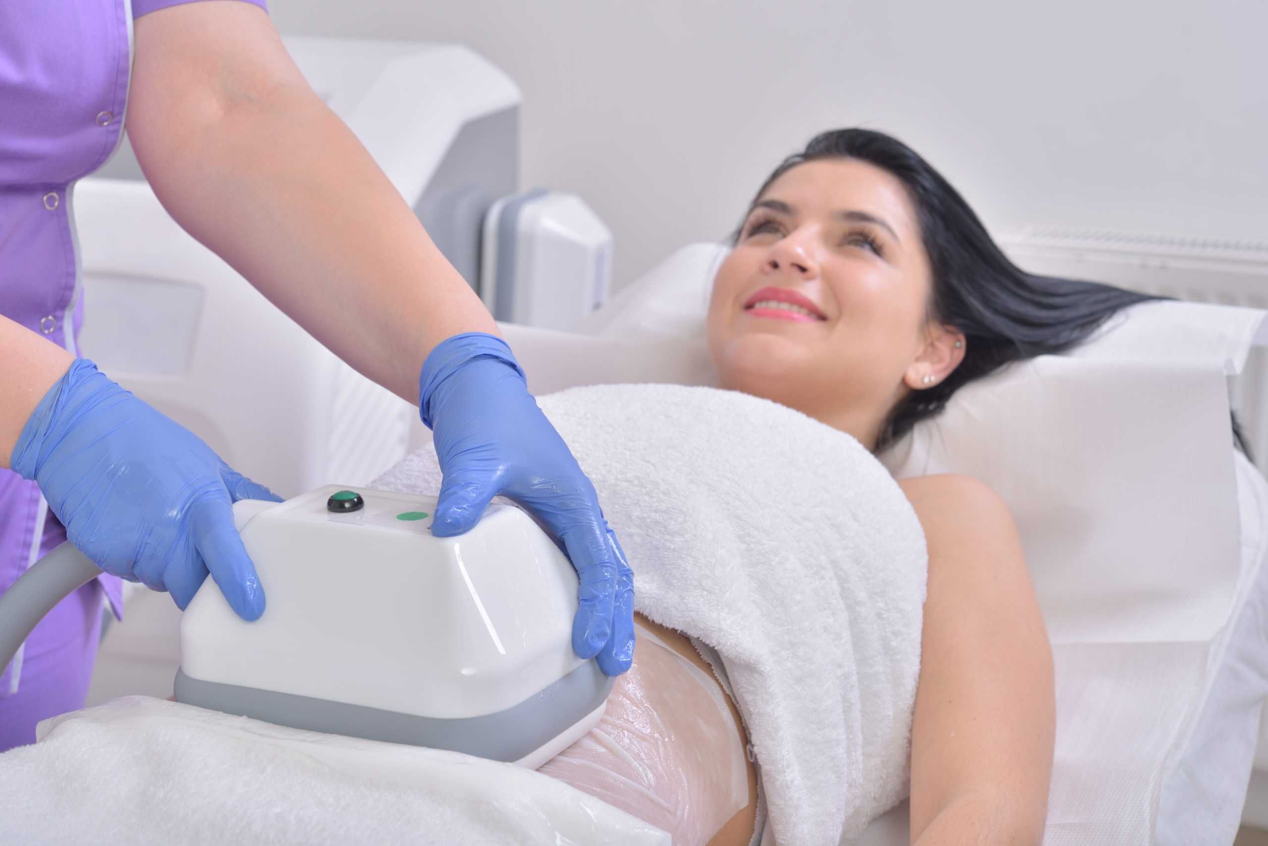Pretty young woman getting cryolipolyse treatment - CoolSculpting